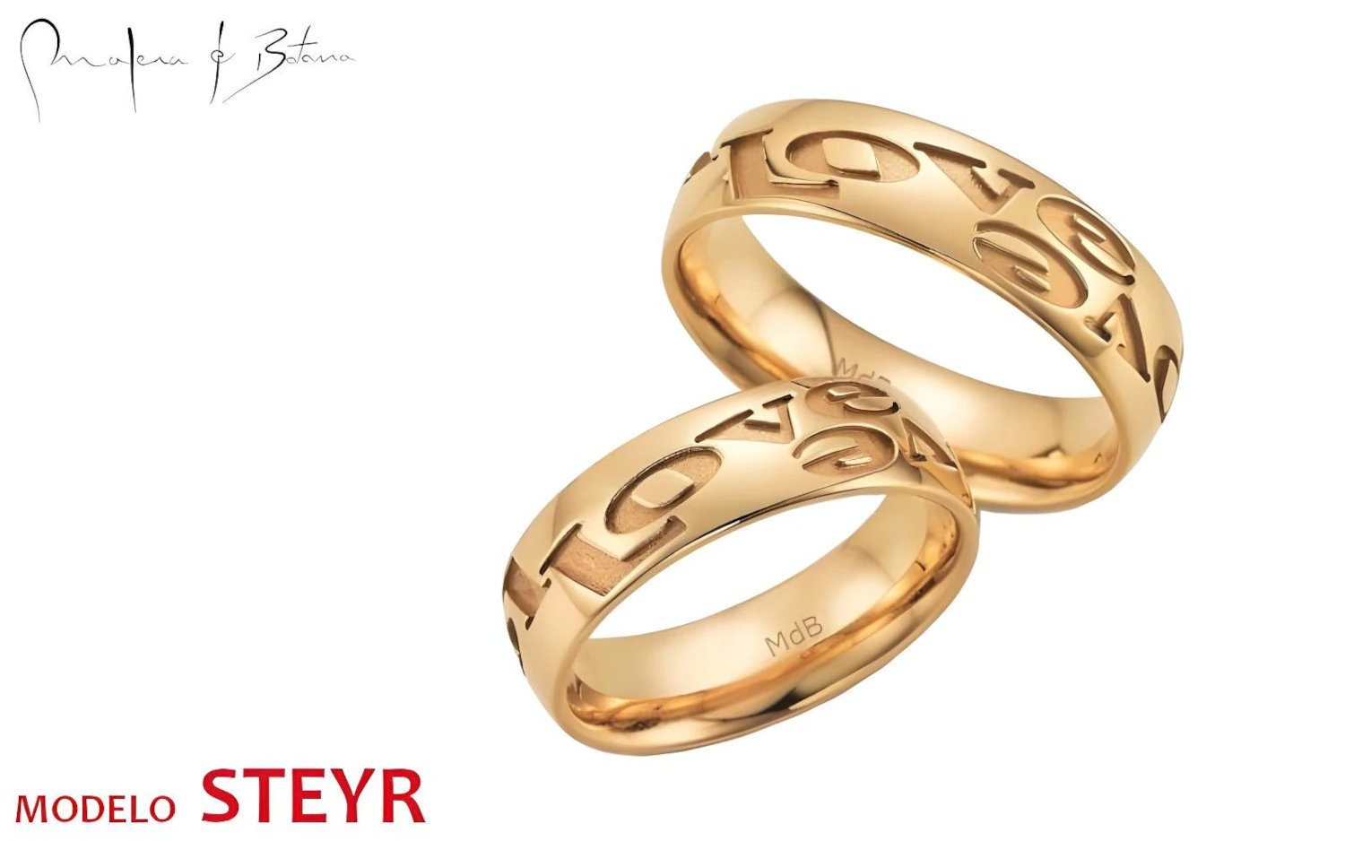 Par de anillos de boda en oro amarillo con letras grabadas en la superficie