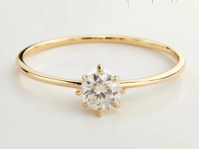 Anillo solitario en oro amarillo 18k con piedra central redonda engastada en seis garras clásicas.