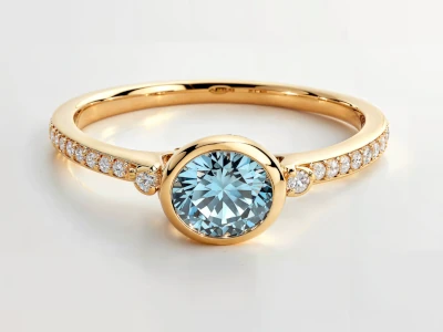 Anillo de promesa en oro amarillo 18k con piedra azul central redonda y piedras laterales en pavé fino.