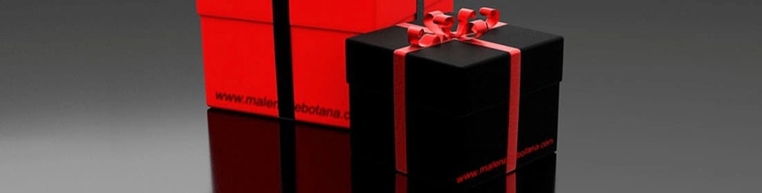 Imagen que muestra dos cajas de regalo, una roja y otra negra, con cintas decorativas, reflejando un diseño moderno y elegante sobre un fondo gris oscuro.